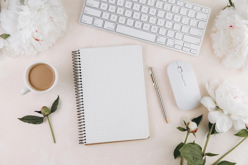 Rebecca Casey Photography blog post on Quitting Social media in 2025. A stock photo of a desk with a cup of tea, notebook and computer keyboard and mouse. Wiltshire Photographer. Maternity Photographer in Wiltshire. Newborn Photographer in Wiltshire.