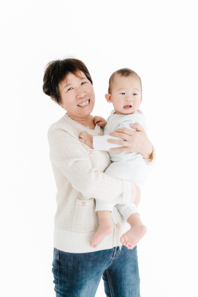 Grandmother and grandchild first birthday photoshoot portrait, natural light studio - Rebecca Casey Photography