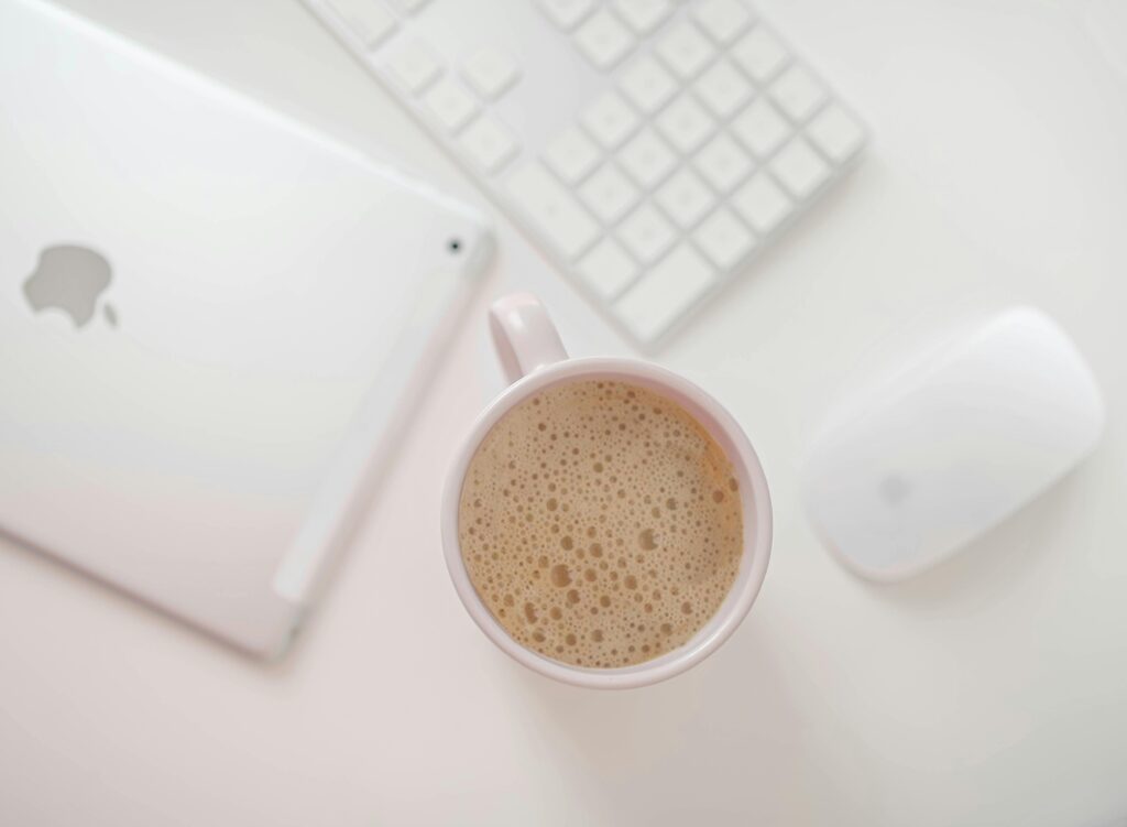 Rebecca Casey Photography blog post on Quitting Social media in 2025. A stock photo of a coffee cup on a desk with an iPad. Wiltshire Photographer. Maternity Photographer in Wiltshire. Newborn Photographer in Wiltshire.