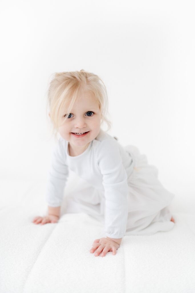 Older sister sibling portrait during a relaxed older newborn session in Westbury photography studio